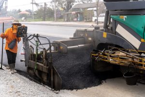 Machines Are Pouring Asphalt To Build Roads For Cars. - Big Easy Asphalt